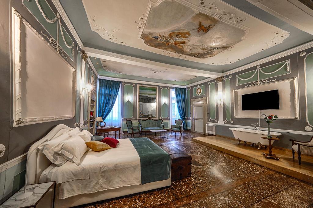 um quarto com uma cama, uma televisão e uma banheira em Residenza Palazzo Negri em Verona