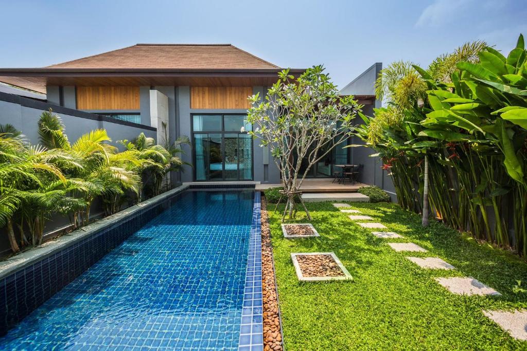 a swimming pool in the backyard of a villa at VILLA MIRIAMA| 2 Bedroom private pool villa in popular Saiyuan Estate | 5 min to Naiharn Beach in Rawai Beach