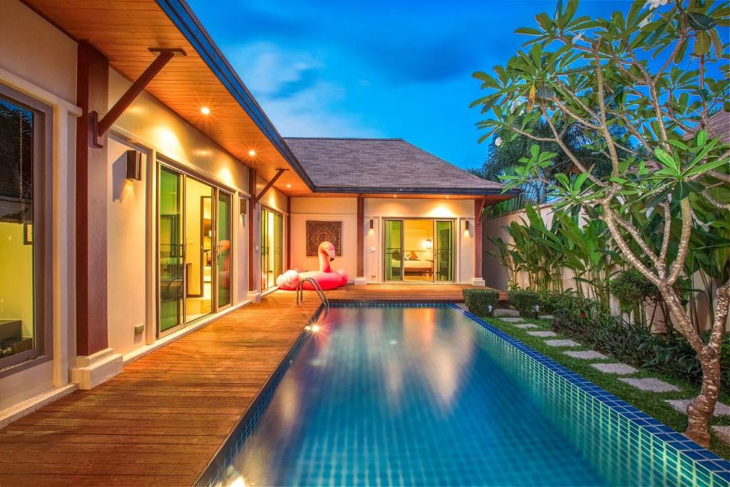 an infinity pool in the backyard of a villa at VILLA BUTON | Private Pool | Kokyang Estate by Tropiclook | Nai harn beach in Nai Harn Beach