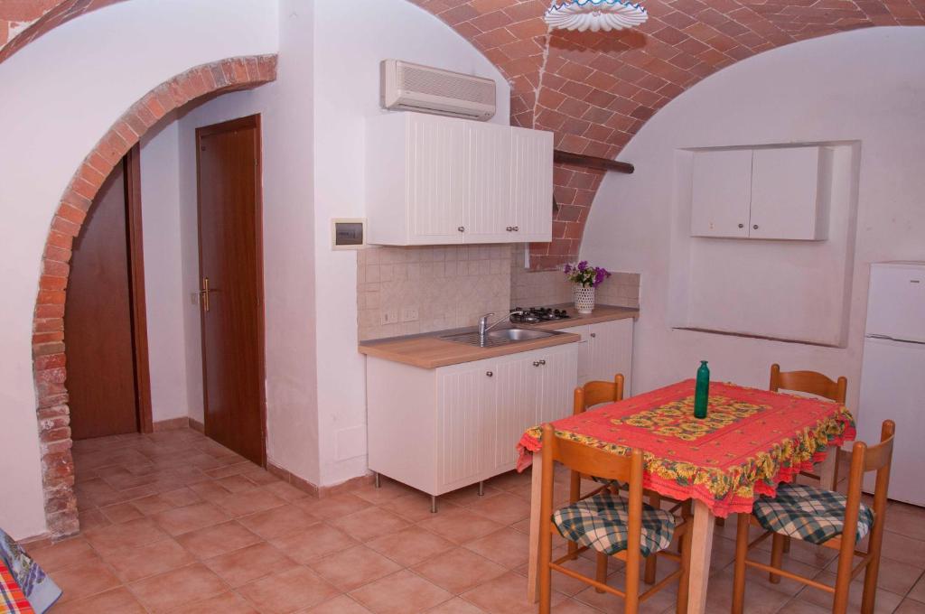 a kitchen with a table and a sink at Podere Valmarina in Follonica