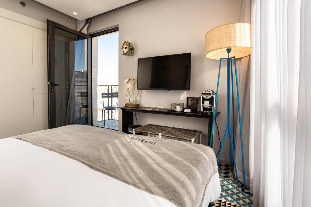 Postel nebo postele na pokoji v ubytování Bezalel Hotel - an Atlas Boutique Hotel
