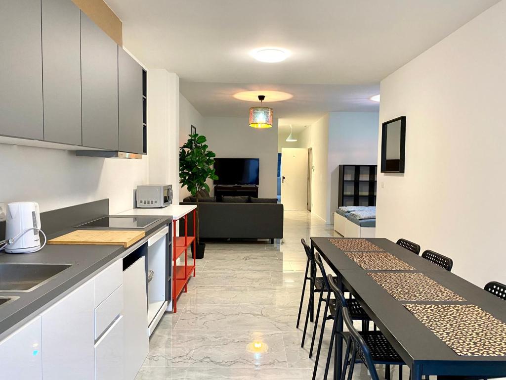 a kitchen with a table and chairs and a living room at Isabel Apartments in Antwerp