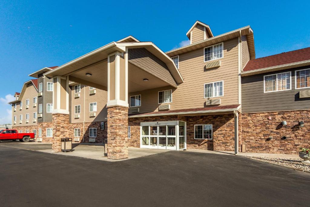 a large building with a parking lot in front of it at Red Roof Inn & Suites Omaha - Council Bluffs in Council Bluffs