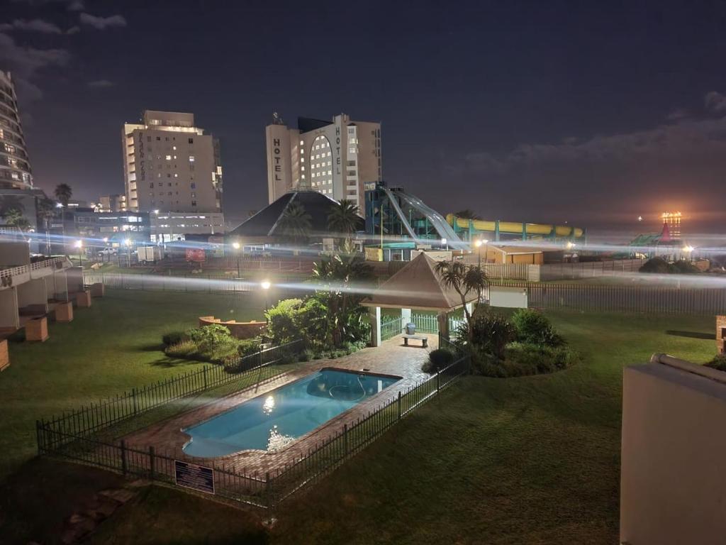 a swimming pool in the middle of a city at night at Diaz De Valle 35 in Mossel Bay