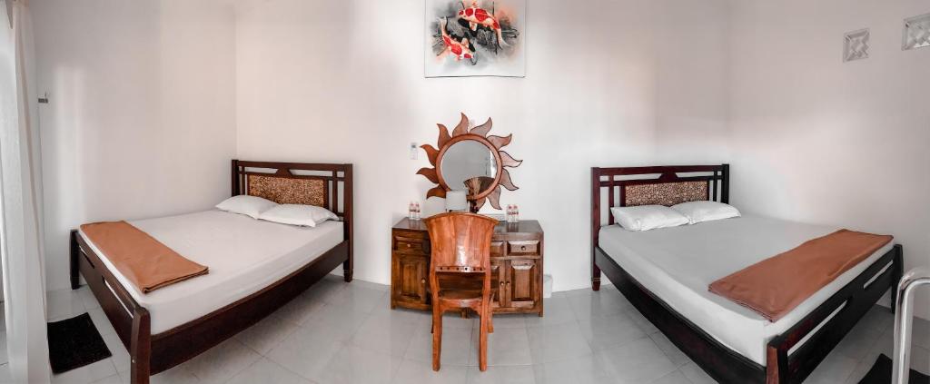 Tempat tidur dalam kamar di Tropical Paradiso Homestay