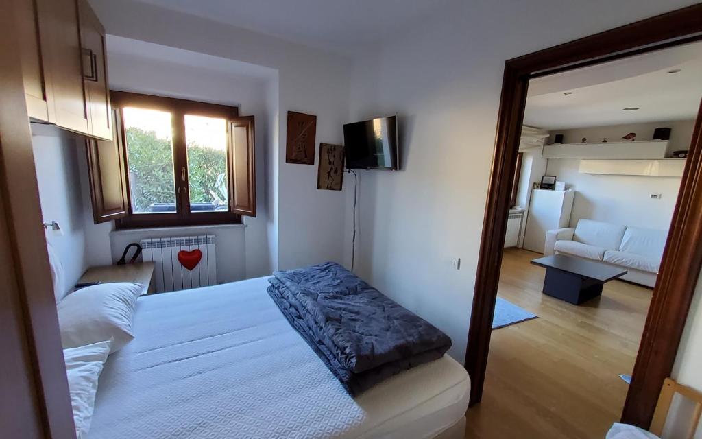 a bedroom with a bed and a living room at Relax Pescasseroli For Ever in Pescasseroli