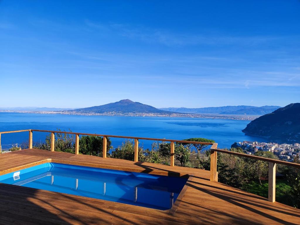 a swimming pool on a deck with a view of the water at Giardino 21 Marzo in Vico Equense