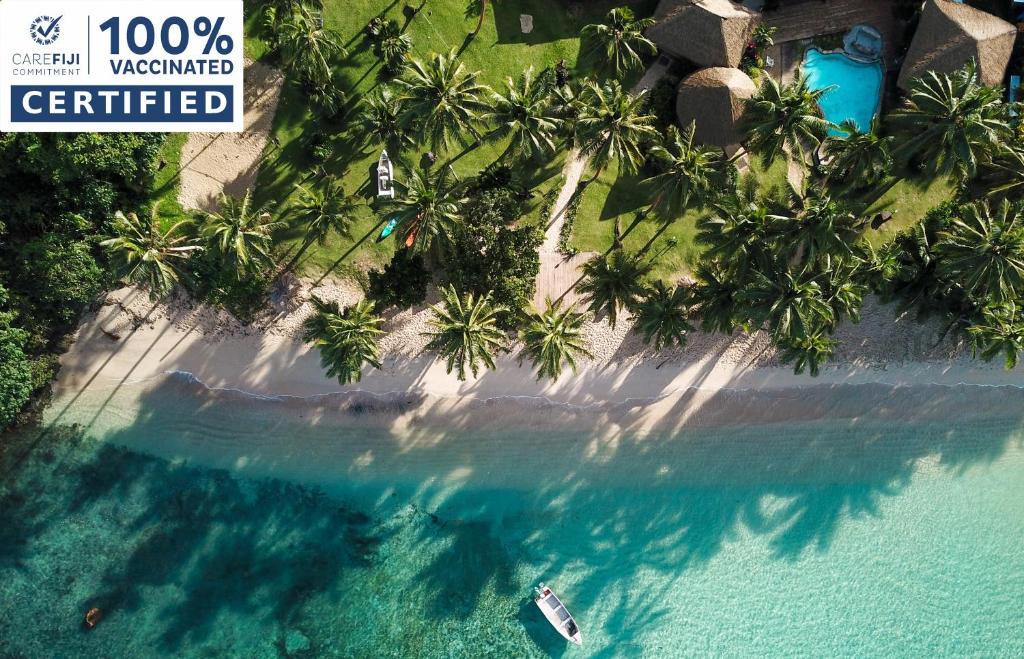 an aerial view of a tropical island with palm trees at Beachouse Resort in Namatakula