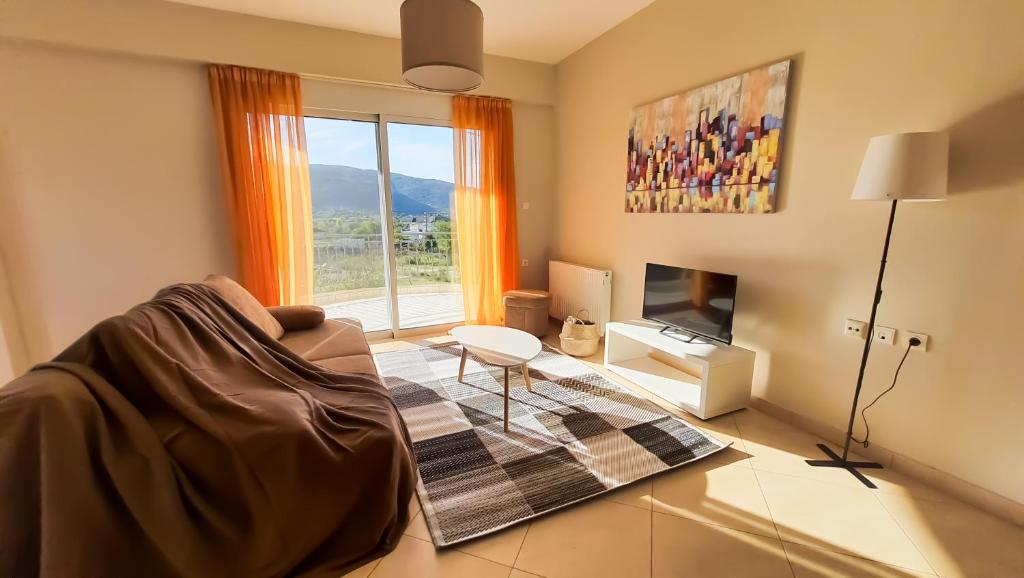 a living room with a couch and a window at Elegant apartment with mountain view in Stavrákion