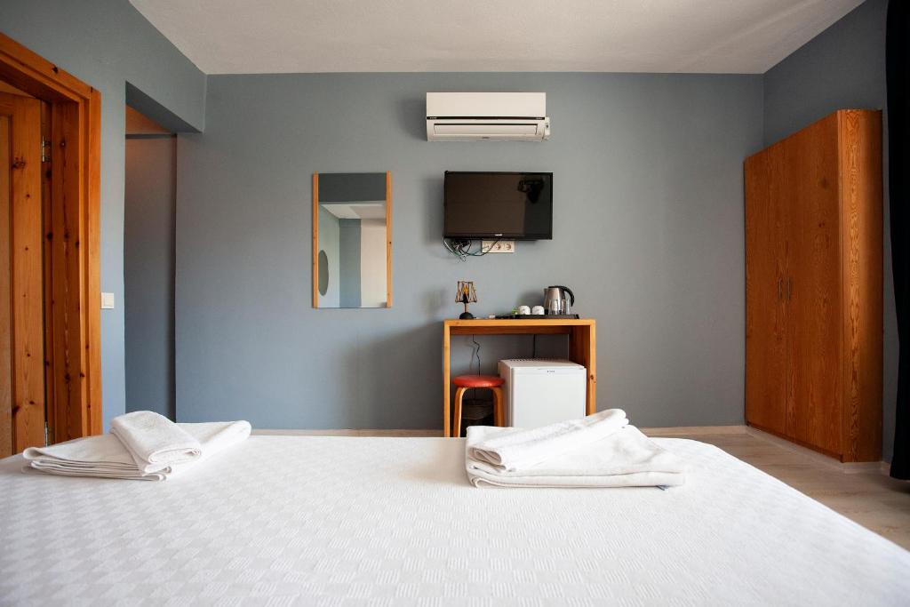 Postel nebo postele na pokoji v ubytování Zephyros City Otel