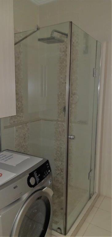 a washing machine in a bathroom with a shower at Ocean Breeze 23 in Kingsborough