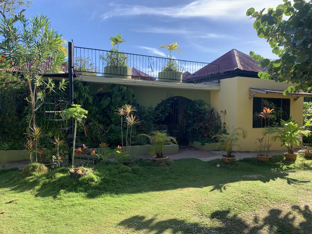 a house with potted plants in the yard at Can Jam Retreat in Negril