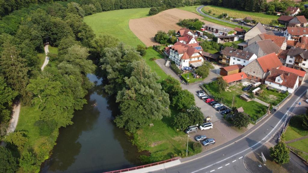 an aerial view of a village with a river at Hotel Saaletalstuben in Gräfendorf