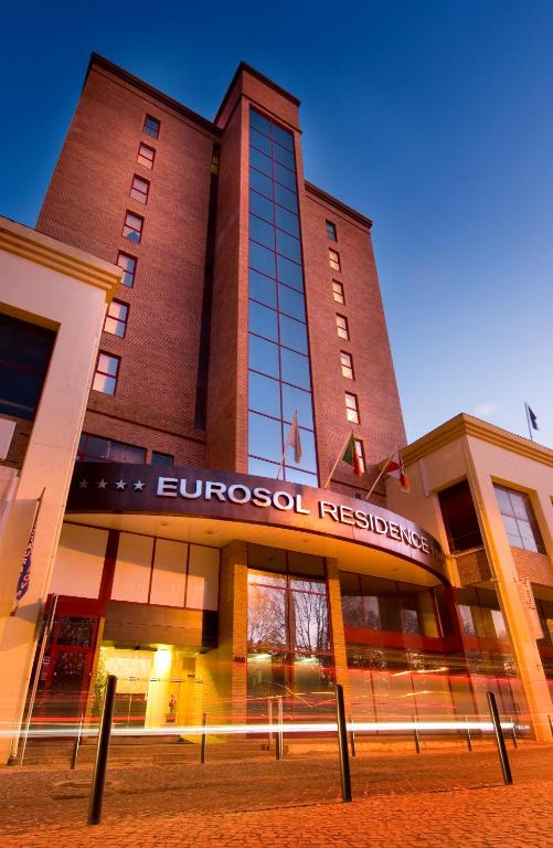 a large building with a sign on the front of it at Eurosol Residence Hotel Apartamento in Leiria