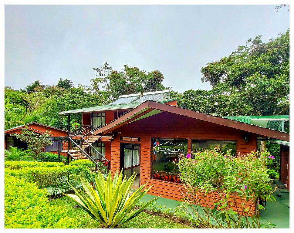 a house with a lot of plants in front of it at Dreams Lodge in Monteverde Costa Rica