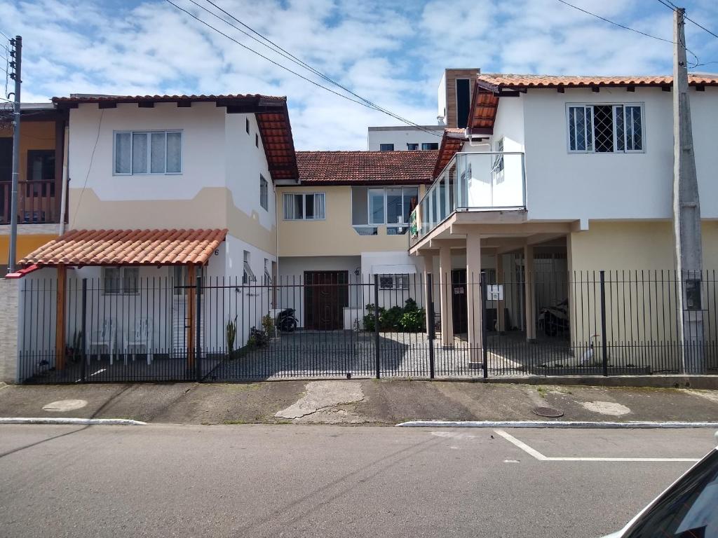 a house with a fence in front of a street at Casa Balneário Camboriú in Balneário Camboriú