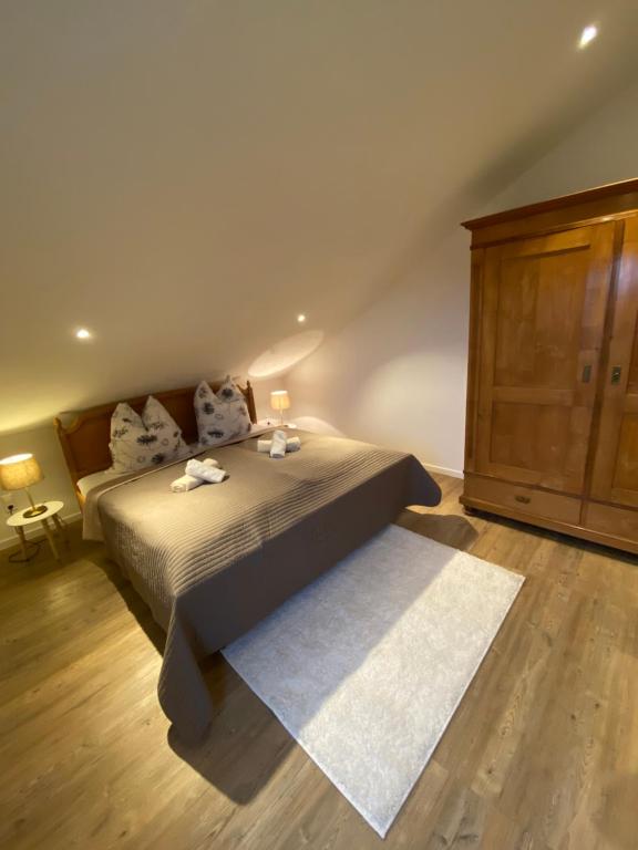 1 dormitorio con 1 cama y armario de madera en Ferienwohnung Lehmann, en Staufen