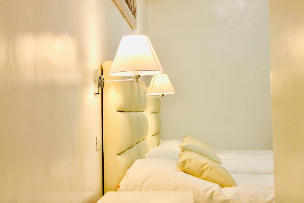 Postel nebo postele na pokoji v ubytování Hotel 900 Toscana