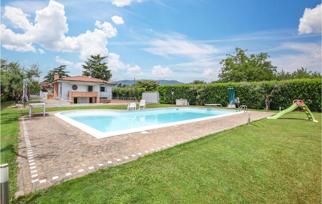 a swimming pool with a slide in a yard at Lovely Home In Velletri With House A Panoramic View in Velletri