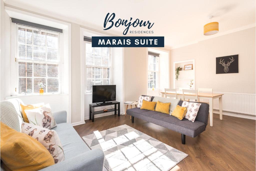 a living room with a couch and a tv at Bright New Town 2BR-1BA, 1 min to George St - Free Parking by Bonjour Residences Edinburgh in Edinburgh