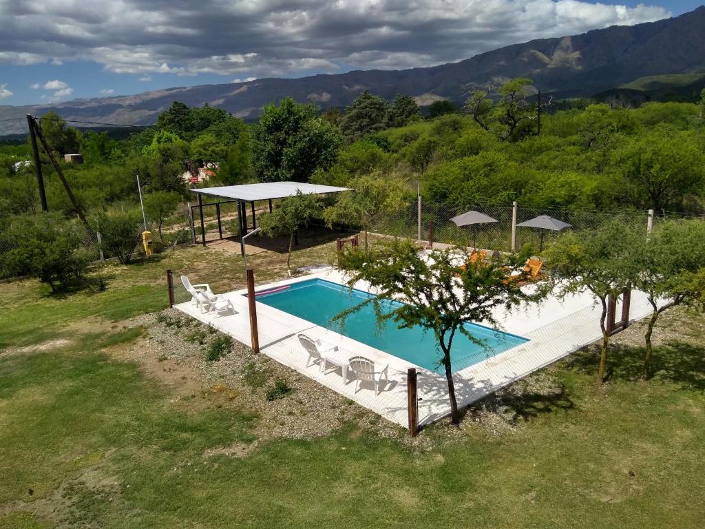 an image of a swimming pool in a field at Cabañas Tierra del Sol in Las Rabonas