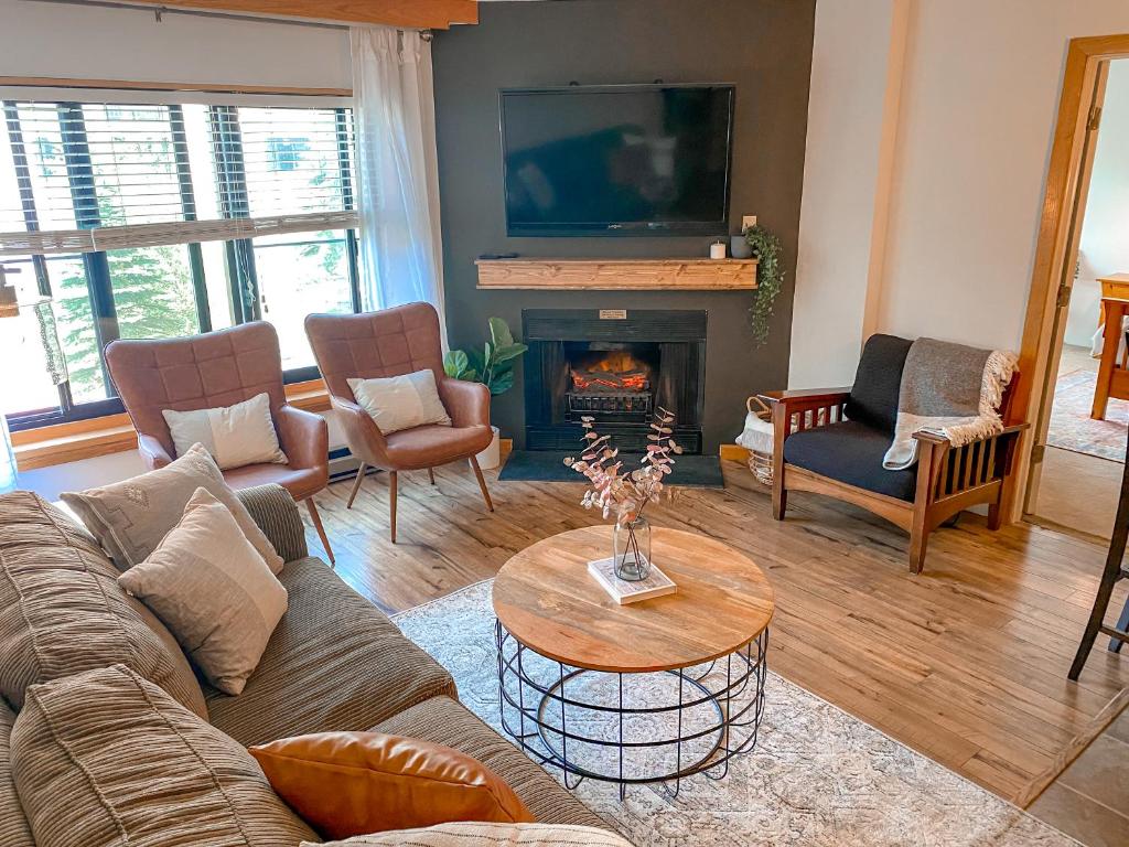 a living room with a couch and a fireplace at Ski-In Ski-out Luxury Condo with Hot Tub and pools in Snowshoe