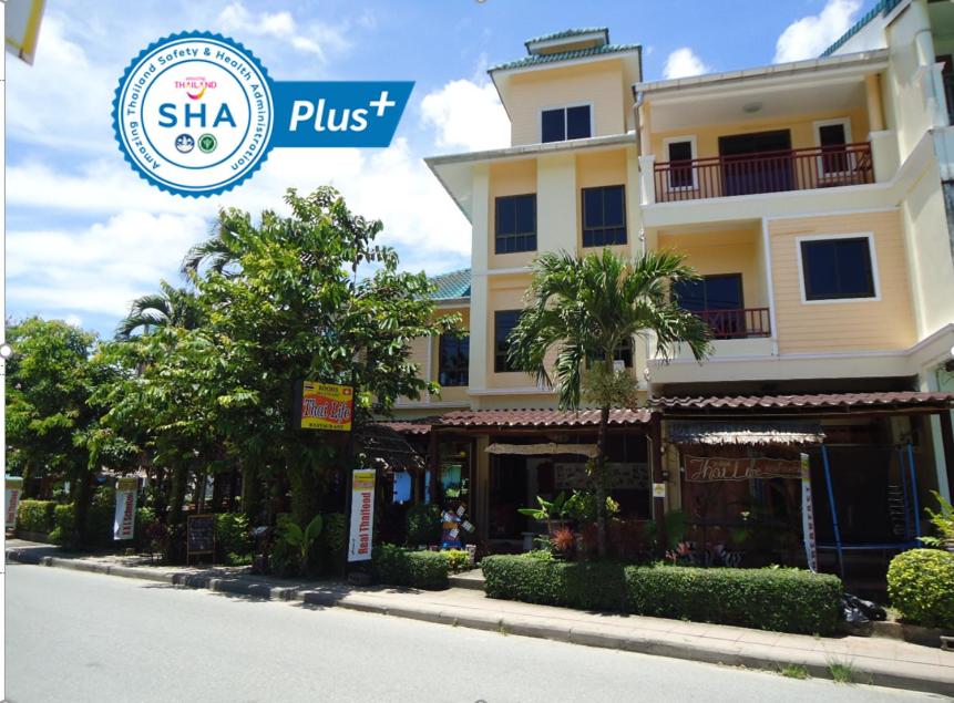 a building with a sign that reads shka plus at Thai Life Guesthouse - SHA EXTRA PLUS in Khao Lak