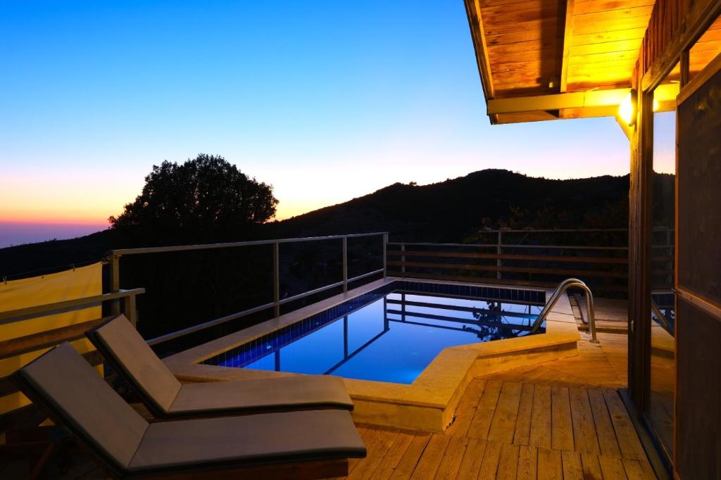 a deck with a swimming pool on top of a house at The moonrise Karaağaç Ölüdeniz in Fethiye