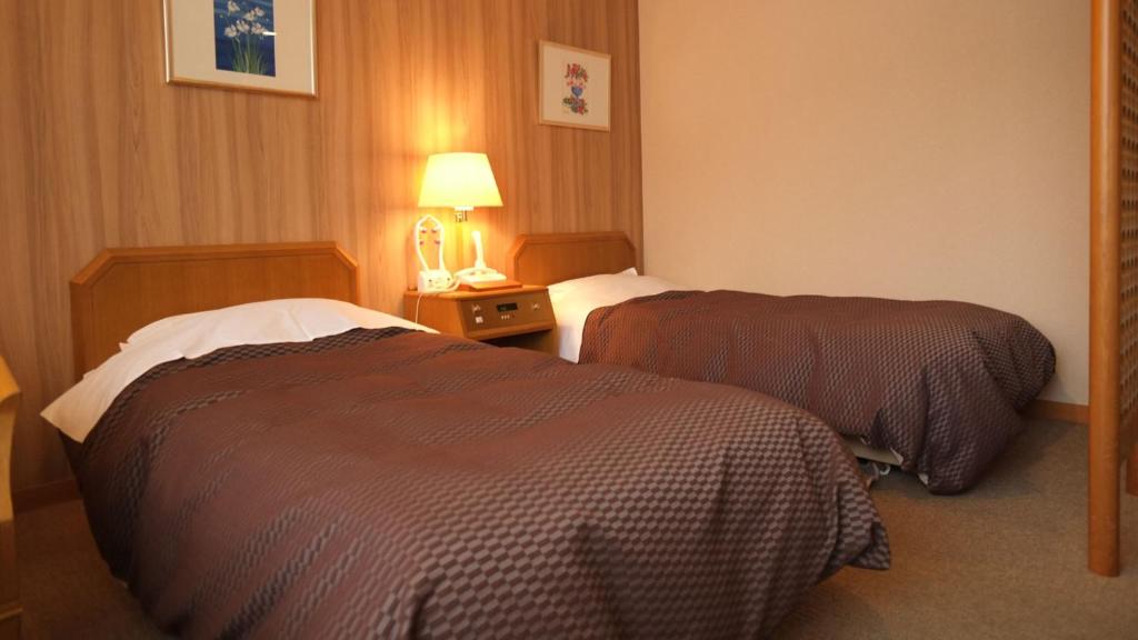 Postel nebo postele na pokoji v ubytování Nikko Senhime Monogatari