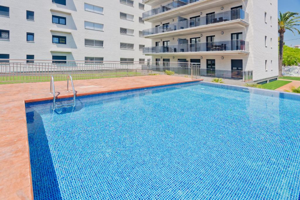 a swimming pool in front of a building at Apartamentos Norte 14 in Salou