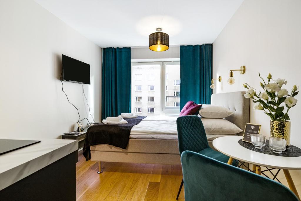 a hotel room with a bed and a table and a window at Bob W Tallinn City Centre - Avangard in Tallinn