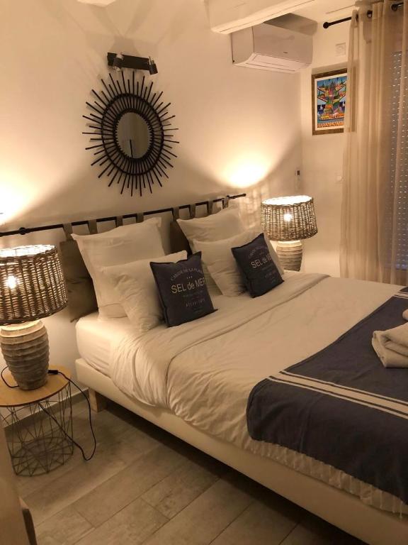 a bedroom with a bed with a mirror on the wall at Maxima Sunset in Sainte-Maxime