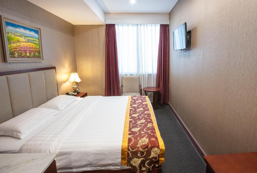 Postel nebo postele na pokoji v ubytování Megaboom City Hotel