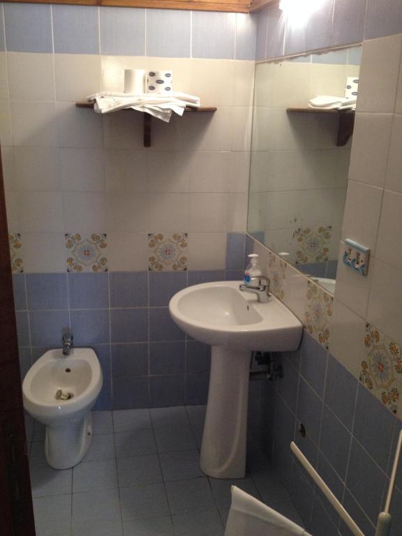 a bathroom with a sink and a toilet at Azzurromare Residence in Procida