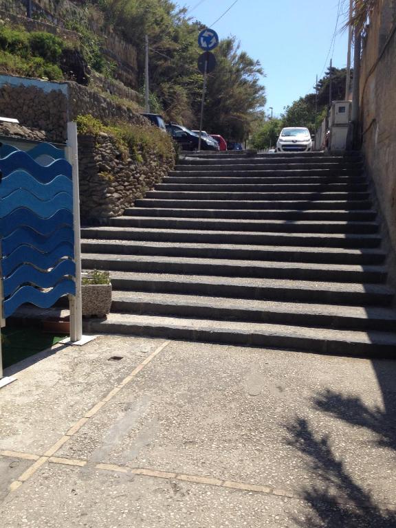 a set of stairs with a car parked at the top at Azzurromare Residence in Procida