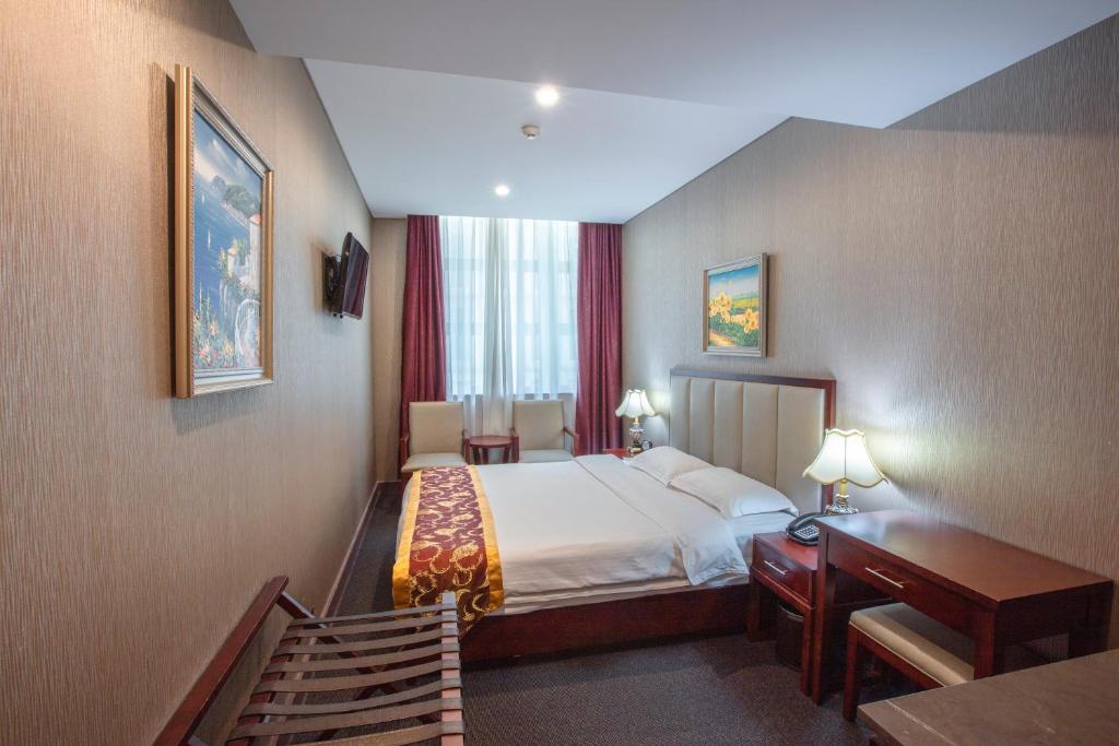 Postel nebo postele na pokoji v ubytování Megaboom City Hotel