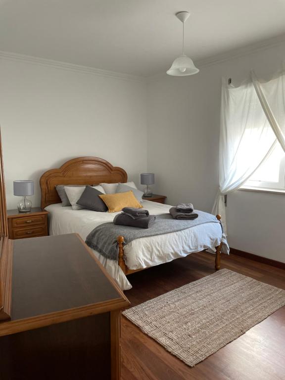 a bedroom with two beds and a table at Maré Baixa in Sines