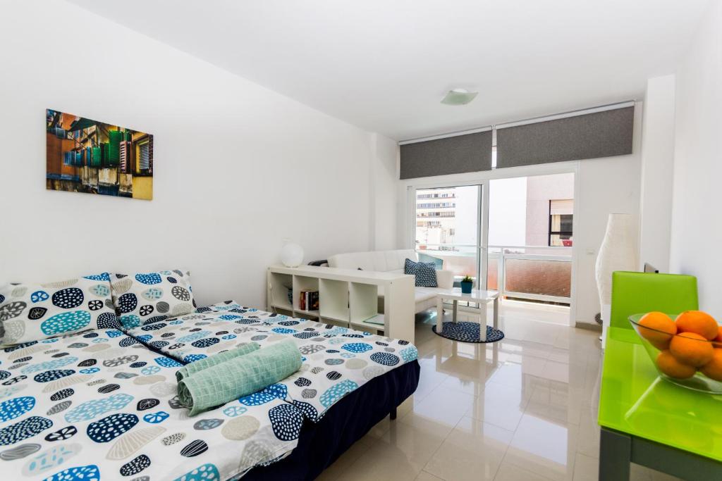a bedroom with a bed and a desk and a room at Apartment Santa Catalina in Las Palmas de Gran Canaria