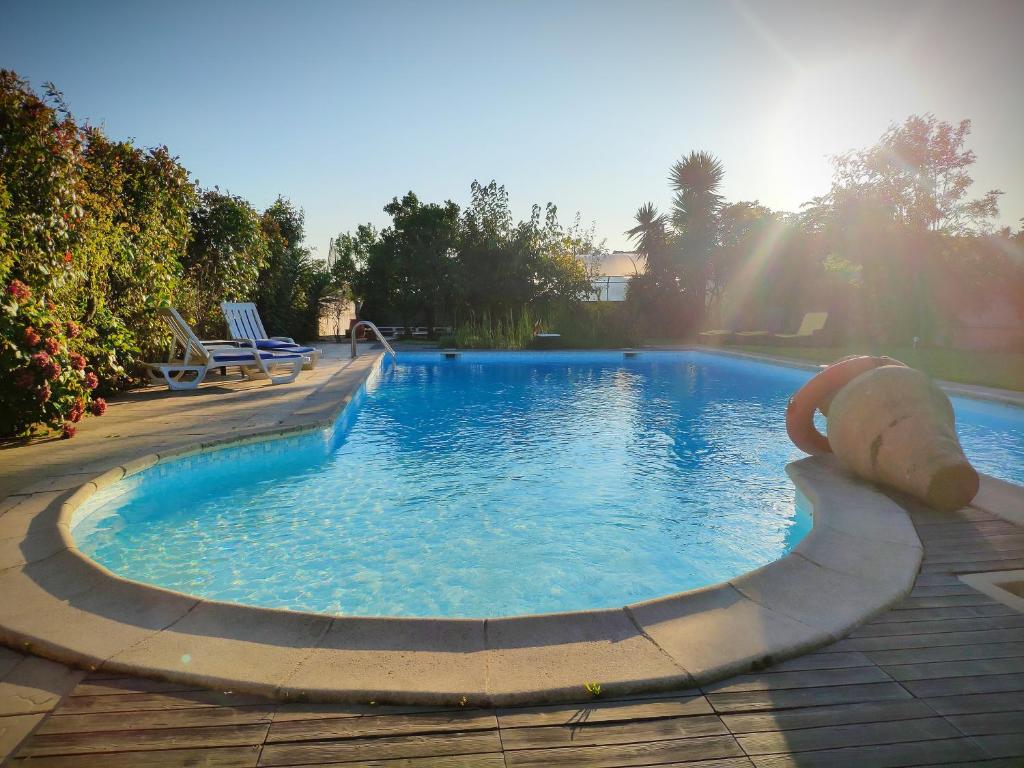 a swimming pool with a teddy bear in the middle at Vila com piscina a 5min da praia de Ofir - Esposende in Esposende