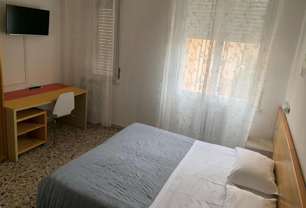 Postel nebo postele na pokoji v ubytování Albergo Moderno