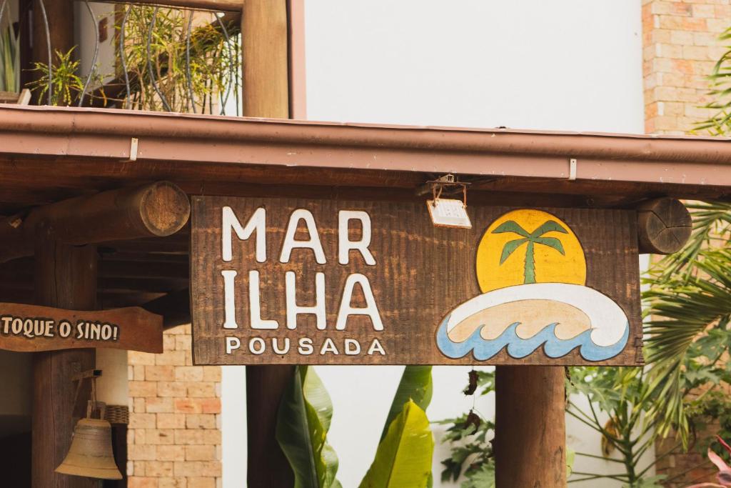 a sign for a mar illica restaurant in a building at Mar Ilha Pousada in Itacaré