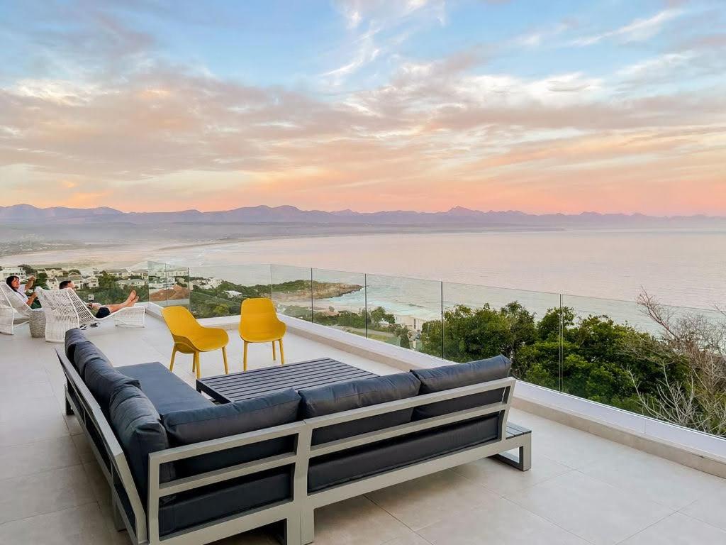 a balcony with a view of the water at Dizzy Hill Villa with 270° Breathtaking Views. Pool + Patio in Plettenberg Bay