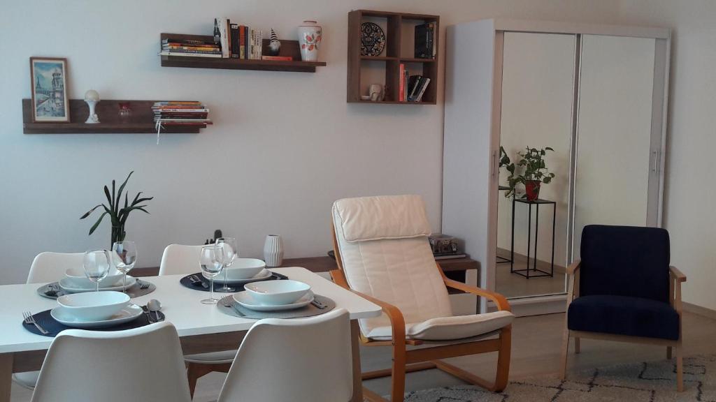 a dining room with a white table and chairs at LILIOM Apartment with FREE PARKING space in Budapest