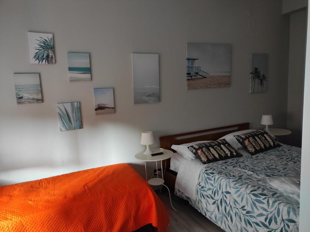 - une chambre avec un lit et des photos sur le mur dans l'établissement Room & Breakfast Santa Maria, à Reggio d'Émilie