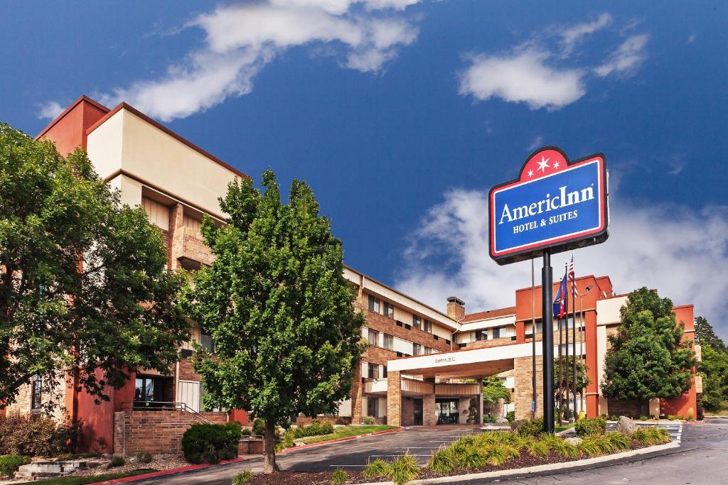 a hotel sign in front of a building at AmericInn by Wyndham Omaha in Omaha