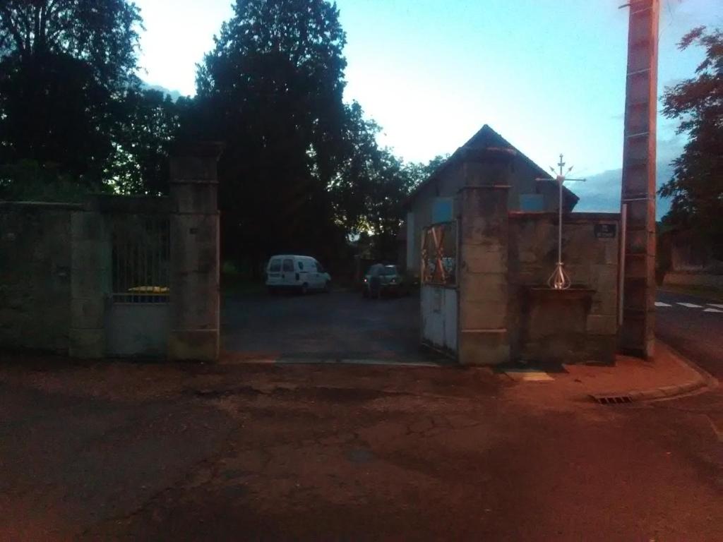 a building with a car parked in a parking lot at Mlle Labeaume in Aigueperse