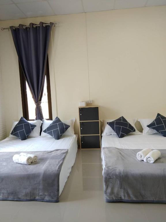 Postel nebo postele na pokoji v ubytování บ้านขวัญกมล