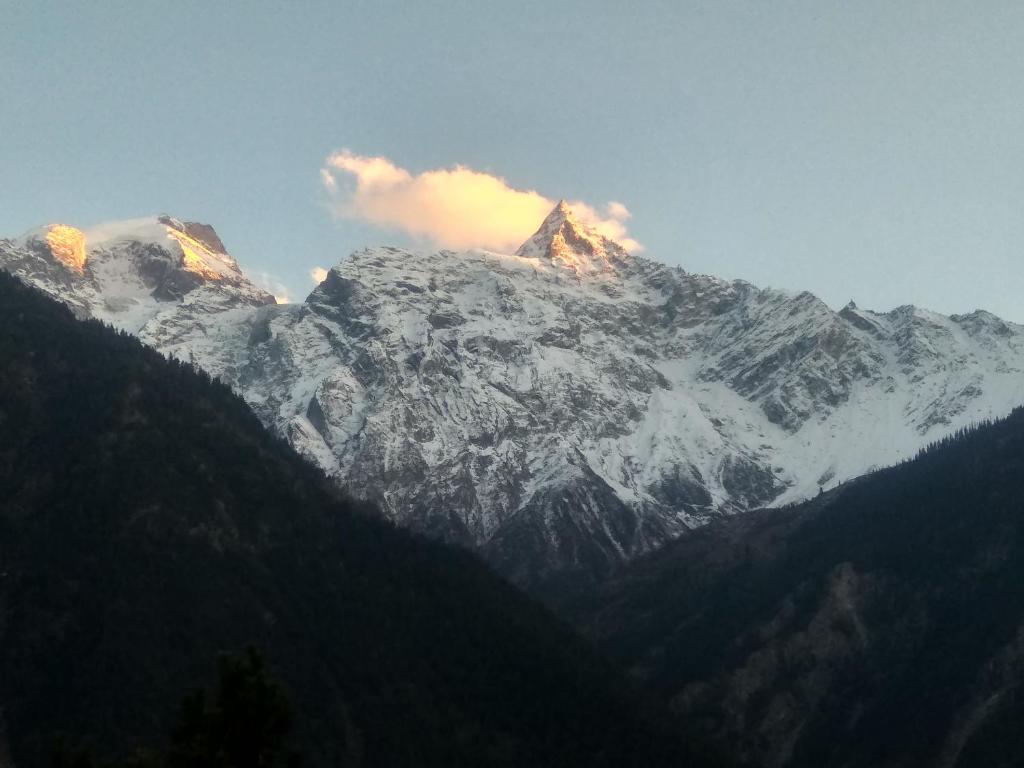 a mountain range with snow on the top of it at Wanderers Homestay -All mountain facing rooms in Kalpa
