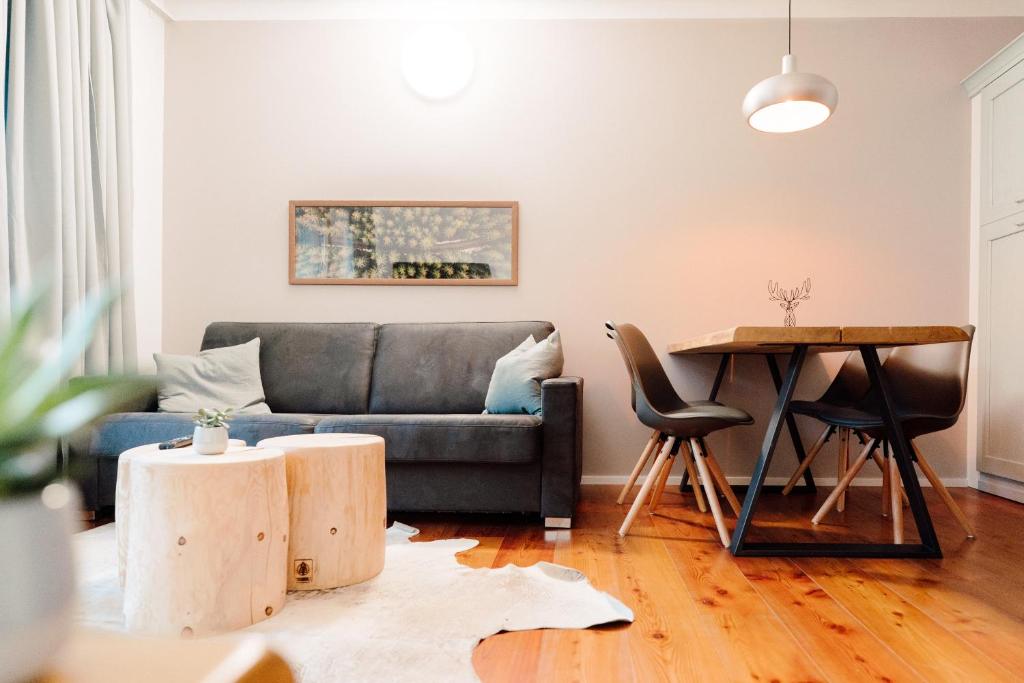 a living room with a couch and a table at Nockventure Apartment Nockberge in Ebene Reichenau