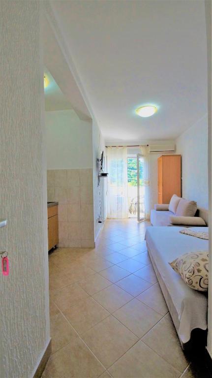 a large room with a bed and a kitchen at MM Apartments in Budva